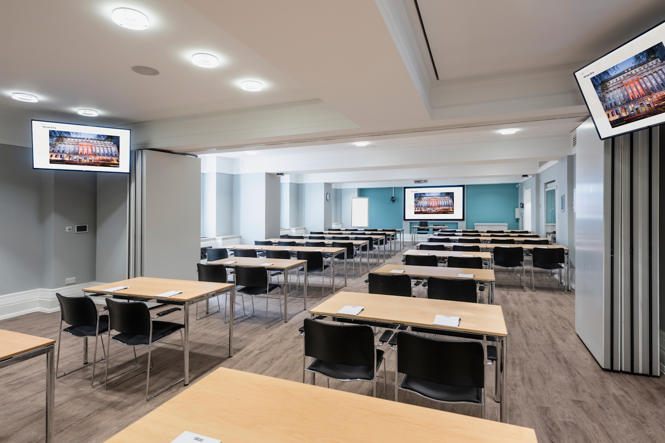 Photograph of the Franks and Steel room at the Wellcome Collection.
Photograph shows a classroom set-up., with desks spaced apart and presenting screens around the outside of the room.