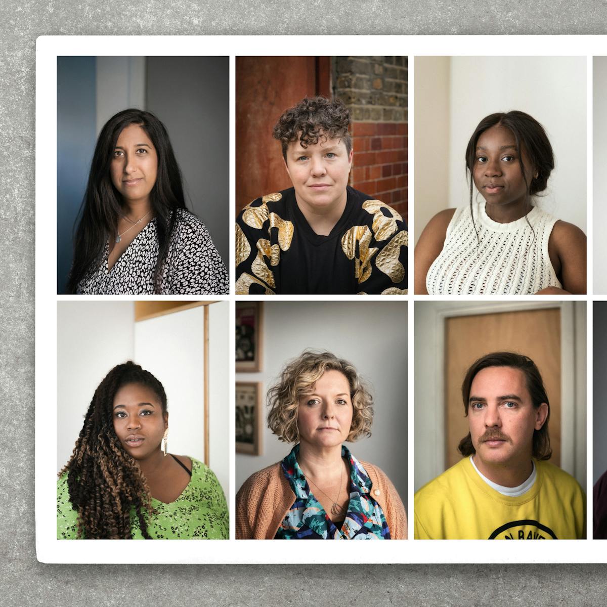 Photograph of a photographic colour print resting on a grey, concrete textured surface, from directly above. The print is slightly raise off the surface, casting a small shadow. The print shows portraits of 10 people, head and shoulders, arranged in a grid of 2 rows and 5 columns. All the people pictured are looking straight to camera.