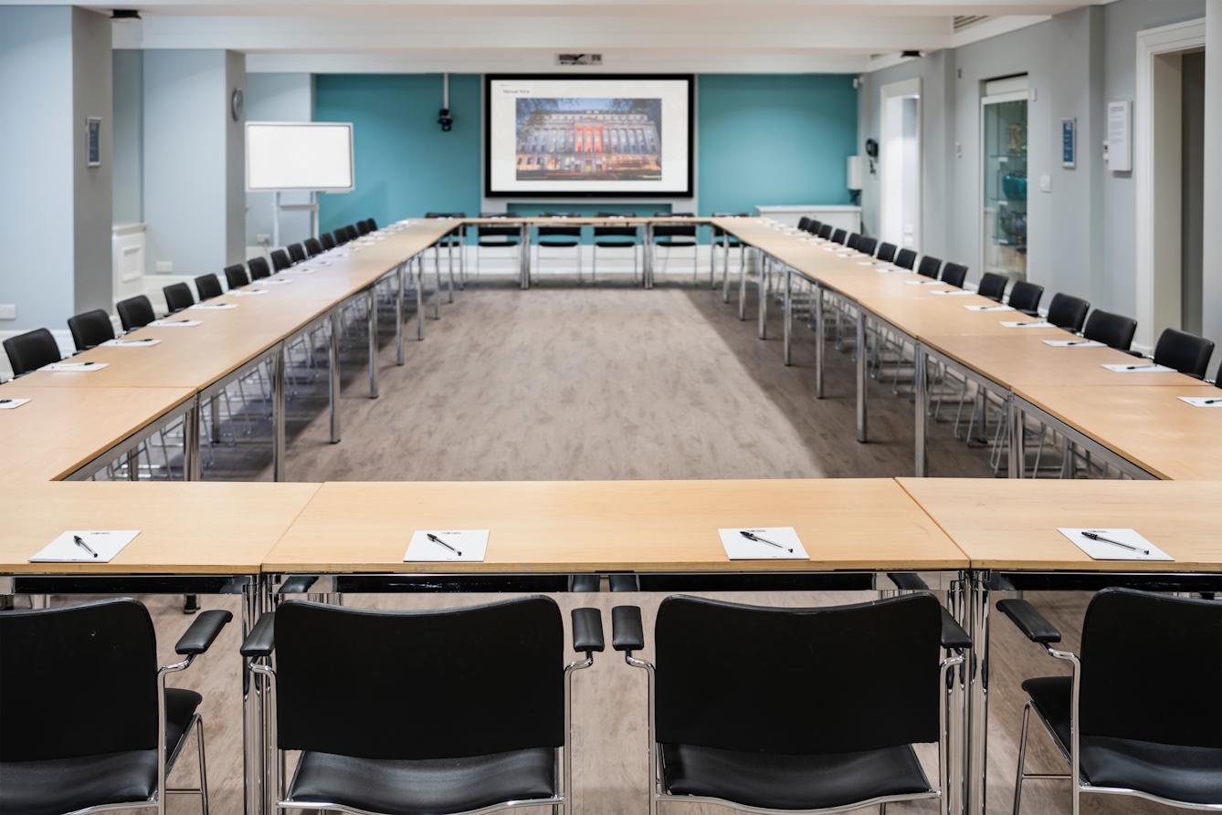 Photograph of the Franks and Steel room at the Wellcome Collection.
Photograph shows a boardroom set-up., with desks laid together in a rectangle shape with chairs around the outside.