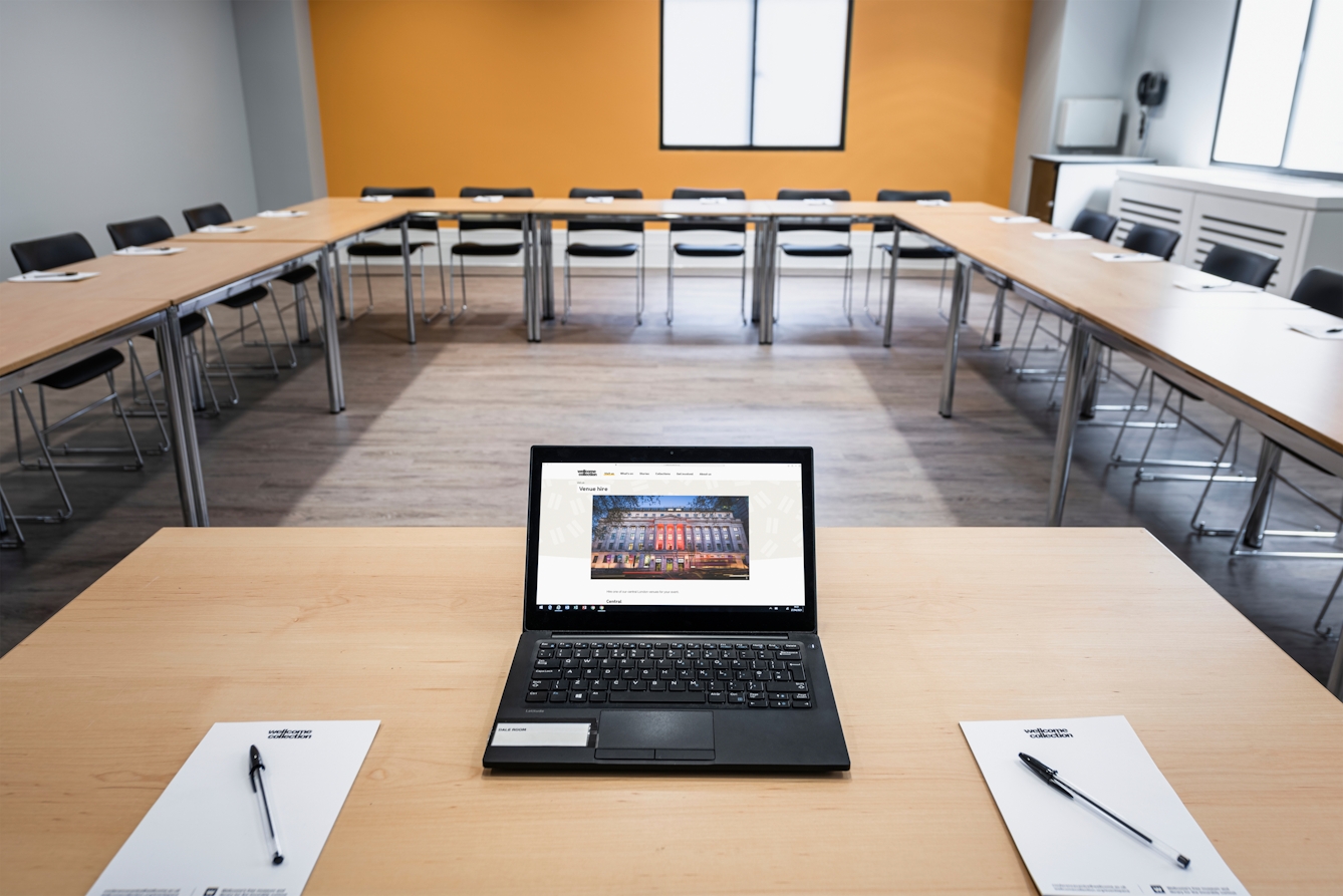 Photograph of the Dale room at the Wellcome Collection.
Photograph shows a boardroom set-up and an open laptop on a desk.