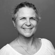 Head and shoulders photographic portrait of Golda Dahan in black and white. 