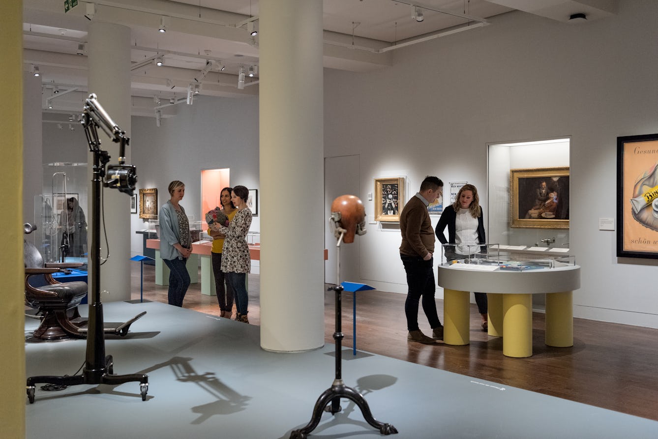 Photograph of visitors exploring the Teeth exhibition at Wellcome Collection.