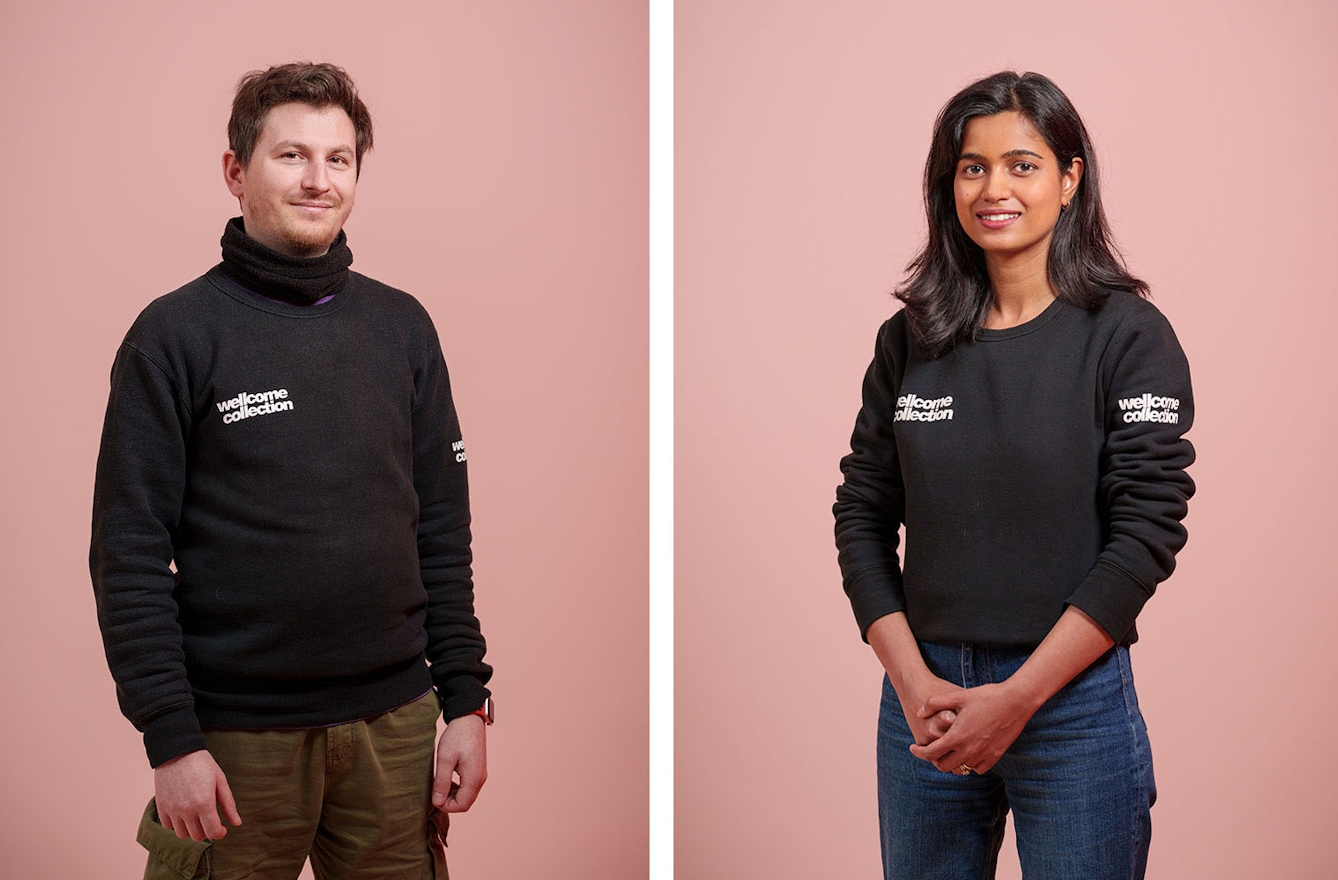 A young man and a young woman wearing tops with Wellcome Collection logos to show they are staff,