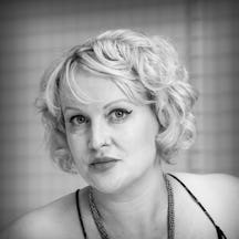 Photographic black and white head and shoulders portrait of Dr Kate Lister.