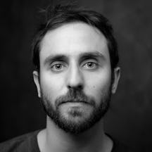 Photographic black and white head and shoulders portrait of Thomas SG Farnetti.