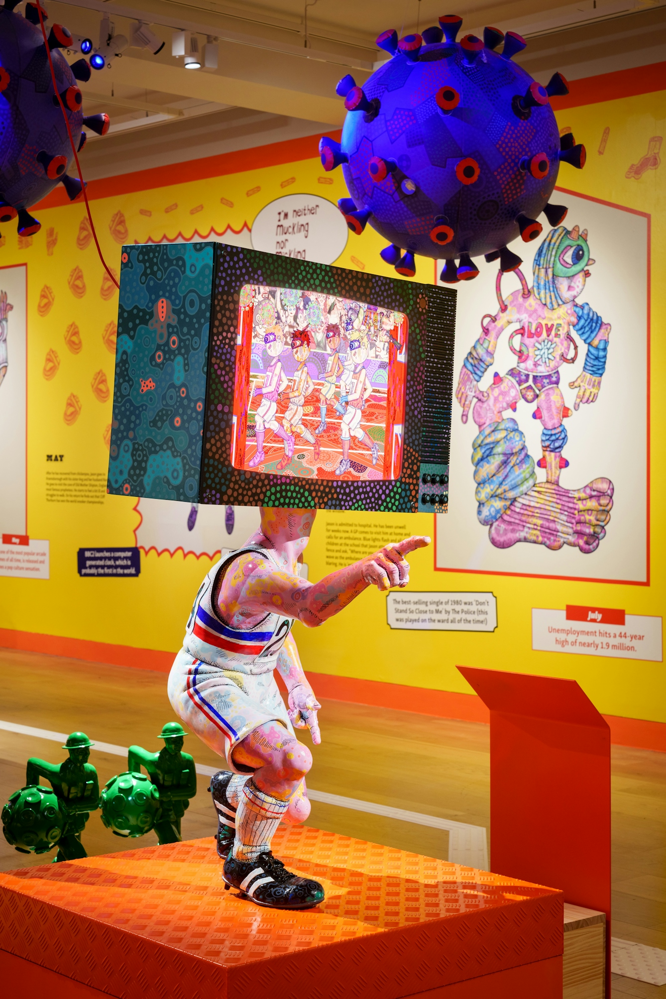 Photo of the sculpture 'Seb Coe' by Jason Willsher Mills. The sculpture of of an athlete running in a race but instead of a head the figuure has a tv set showing the other runners in the race.