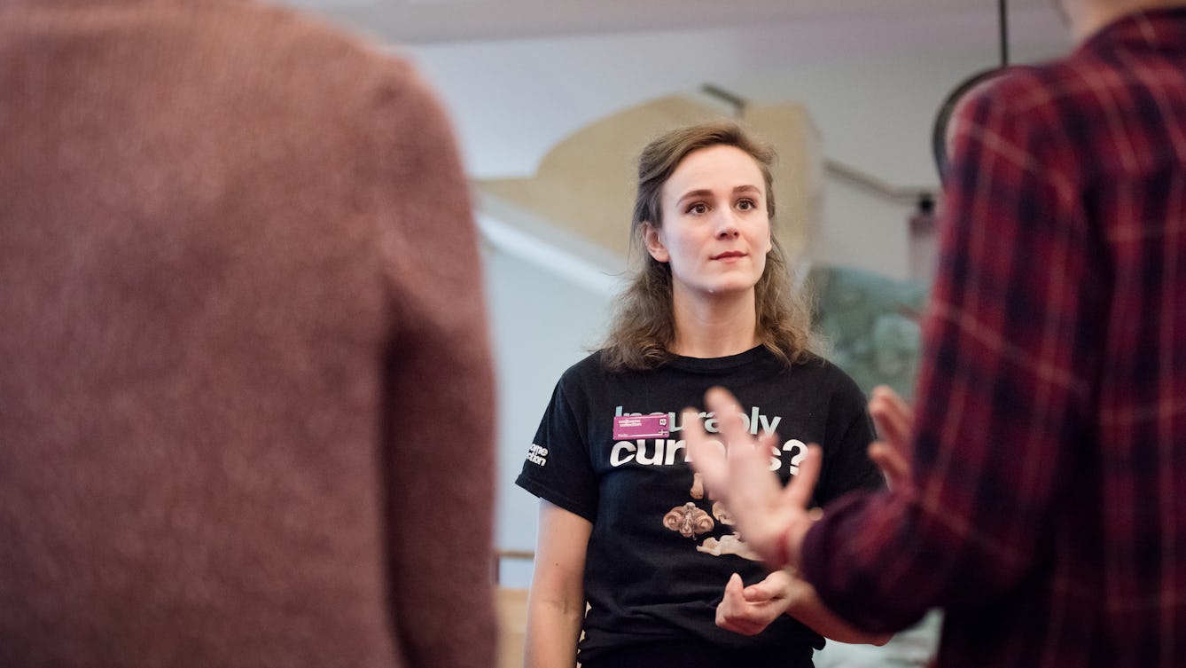 Photograph of a Wellcome Collection Visitor Experience Assistant conducting a tour of the Reading Room. 